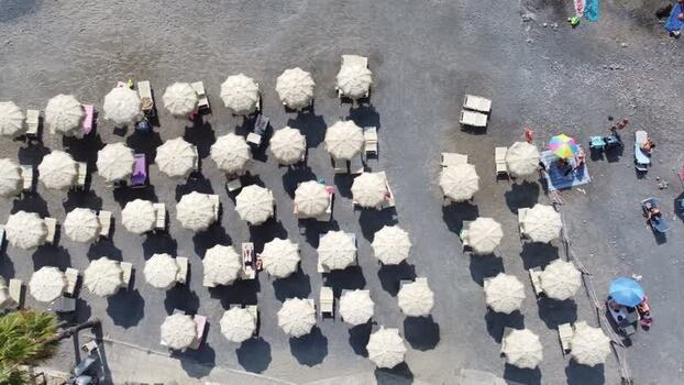 Aerial view of white sun umbrellas on a pebble beach Italy. Aerial view of white sun umbrellas on a pebble beach Italy.