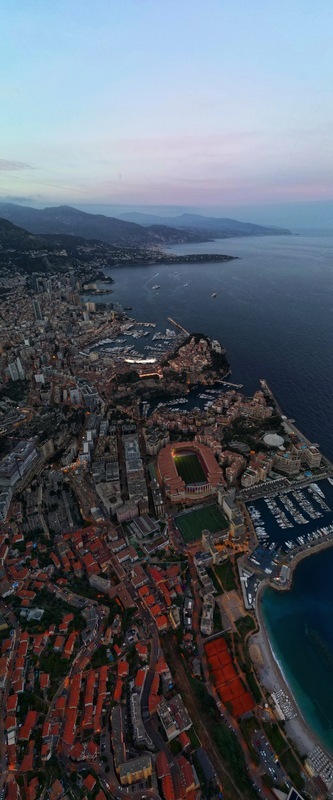 Aerial view of Monaco City with the Stade Louis II and the harbor under a twilight sky Monaco Monaco.