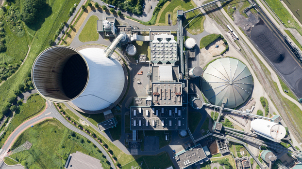 Aerial view of Walsum power plant featuring a large cooling tower industrial buildings and a storage dome surrounded by green fields in Duisburg Nordrhein Westfalen Germany. Aerial view of Walsum power plant featuring a large cooling tower industrial buildings and a storage dome surrounded by green fields in Duisburg Nordrhein Westfalen Germany.