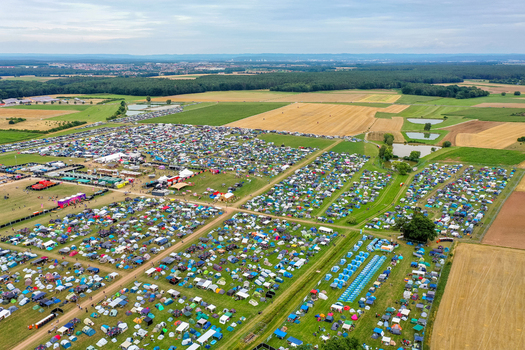 Herzogenaurach Germany 25 July 2025 Aerial view of the Open Beatz Festival campsite featuring thousands of colorful tents on green fields surrounded by forests and agricultural land. Herzogenaurach Germany 25 July 2025 Aerial view of the Open Beatz Festival campsite featuring thousands of colorful tents on green fields surrounded by forests and agricultural land.