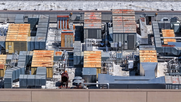 Aerial view of industrial HVAC units and ventilation ductwork on a semiconductor company rooftop in San Jose California United States.
