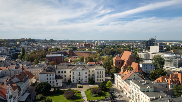 Aerial view of the vibrant tapestry of terracotta roofs and creamy facades punctuated by the majestic St. Martin and Nicholas Church Bydgoszcz Województwo kujawsko pomorskie Poland. Aerial view of the vibrant tapestry of terracotta roofs and creamy facades punctuated by the majestic St. Martin and Nicholas Church Bydgoszcz Województwo kujawsko pomorskie Poland.