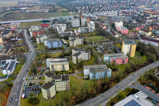 Aerial view of residential apartment blocks and urban housing surrounded by green spaces and streets in Forchheim Bavaria Germany.