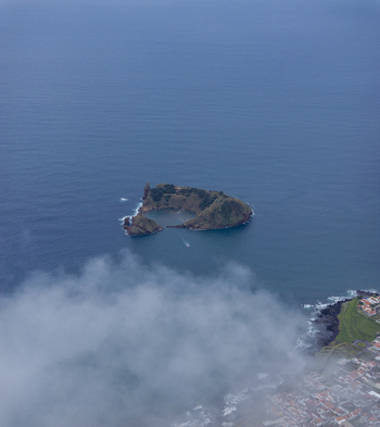 Aerial view of Ilheu de Vila Franca do Campo a volcanic islet with a natural circular crater lagoon surrounded by the Atlantic Ocean near the coast of Sao Pedro Acores Portugal. Aerial view of Ilheu de Vila Franca do Campo a volcanic islet with a natural circular crater lagoon surrounded by the Atlantic Ocean near the coast of Sao Pedro Acores Portugal.