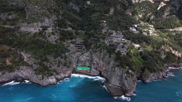 Aerial view of coastal cliffs and buildings Italy.