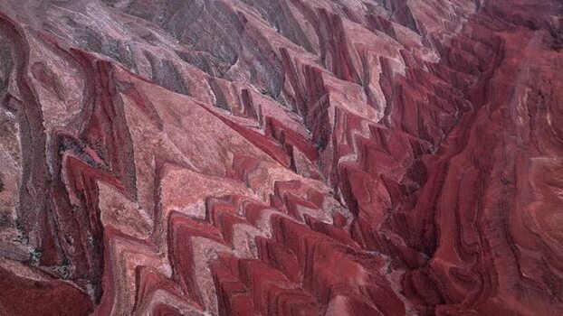 Aerial view of red rock formations and jagged ridges in Moab United States.