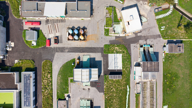 Aerial view of a water treatment plant with industrial tanks paved pathways and surrounding green areas in Milan Lombardy Italy. Aerial view of a water treatment plant with industrial tanks paved pathways and surrounding green areas in Milan Lombardy Italy.