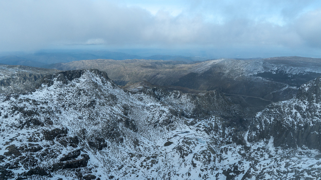 Aerial view of the Glacial Valley of Zezere with snow covered rocky peaks and low hanging clouds in Manteigas Guarda District Portugal. Aerial view of the Glacial Valley of Zezere with snow covered rocky peaks and low hanging clouds in Manteigas Guarda District Portugal.