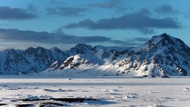 Aerial view of snowy mountains and frozen sea Greenland. Aerial view of snowy mountains and frozen sea Greenland.