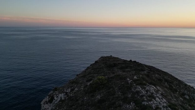 Aerial view of rocky cliff at sunset Spain.