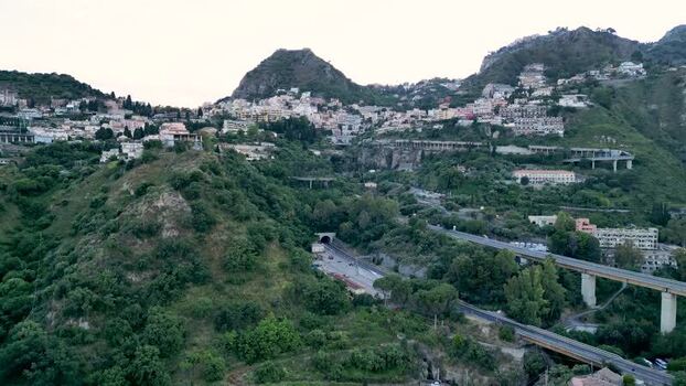 Aerial view of the hillside town of Taormina and highway Italy.