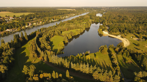 Aerial view of the Seine river winding through the lush green landscape and forests of Chartrettes Ile de France France. Aerial view of the Seine river winding through the lush green landscape and forests of Chartrettes Ile de France France.