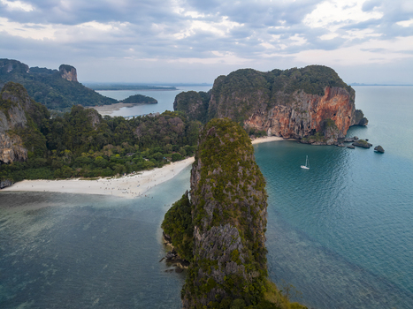 Aerial view of dramatic limestone cliffs rising from turquoise waters fringed by pristine beaches Railay Beach Krabi Thailand. Aerial view of dramatic limestone cliffs rising from turquoise waters fringed by pristine beaches Railay Beach Krabi Thailand.