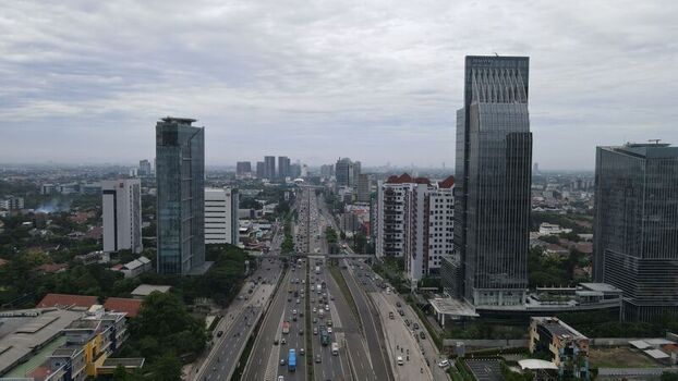 Aerial view of Jalan Tol Depok Antasari highway with modern skyscrapers and lush greenery in Kecamatan Cilandak Daerah Khusus Ibukota Indonesia. Aerial view of Jalan Tol Depok Antasari highway with modern skyscrapers and lush greenery in Kecamatan Cilandak Daerah Khusus Ibukota Indonesia.