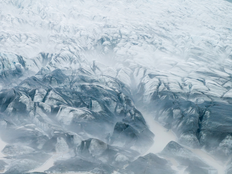 Aerial view of the rugged surface of a glacier in Iceland featuring deep crevasses layers of ice and glacial meltwater flowing through the landscape Iceland. Aerial view of the rugged surface of a glacier in Iceland featuring deep crevasses layers of ice and glacial meltwater flowing through the landscape Iceland.