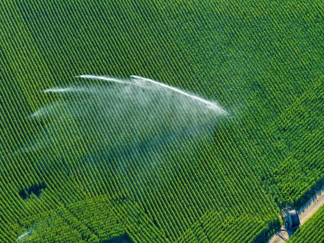 Aerial view of a lush green agricultural field being watered by irrigation sprinklers in Hombourg Grand Est France. Aerial view of a lush green agricultural field being watered by irrigation sprinklers in Hombourg Grand Est France.