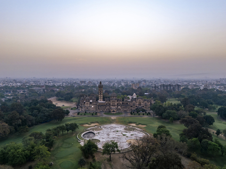 Vadodara India 14 March 2026 Aerial view of Laxmi Vilas Palace with its intricate Indo Saracenic architecture sprawling green gardens and a circular fountain area under a soft twilight sky. Vadodara India 14 March 2026 Aerial view of Laxmi Vilas Palace with its intricate Indo Saracenic architecture sprawling green gardens and a circular fountain area under a soft twilight sky.