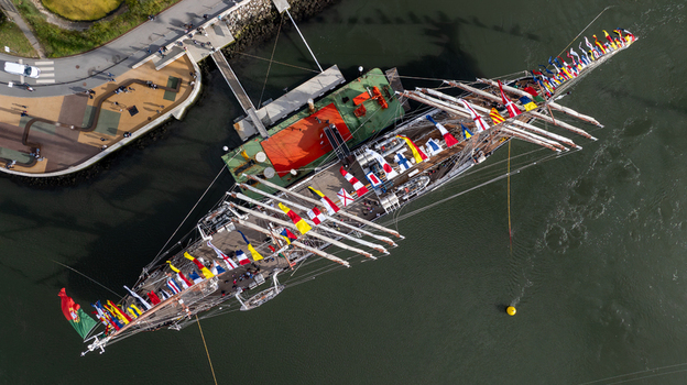 Aerial view of the tall ship NRP Sagres decorated with signal flags navigating the Canal de Aveiro near the salt pans Aveiro Aveiro Portugal. Aerial view of the tall ship NRP Sagres decorated with signal flags navigating the Canal de Aveiro near the salt pans Aveiro Aveiro Portugal.