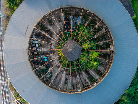 Aerial view of the historic locomotive roundhouse Rummelsburg with its circular roof structure and overgrown interior located in Berlin Berlin Germany. Aerial view of the historic locomotive roundhouse Rummelsburg with its circular roof structure and overgrown interior located in Berlin Berlin Germany.