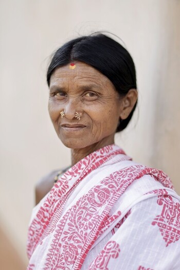 Odisha India 26 March 2026 View of a woman with aged weathered skin adorned in a white and red sari her eyes reflecting a lifetime of stories. Odisha India 26 March 2026 View of a woman with aged weathered skin adorned in a white and red sari her eyes reflecting a lifetime of stories.