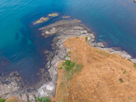 Aerial view of the rocky coastline at Arapya with dry golden grass and clear blue sea in Burgas Bulgaria. Aerial view of the rocky coastline at Arapya with dry golden grass and clear blue sea in Burgas Bulgaria.