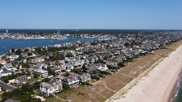 Aerial view of Mantoloking featuring coastal residential homes sandy beach and calm bay waters in Mantoloking New Jersey United States.
