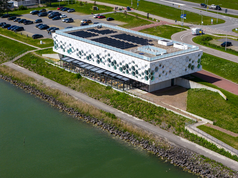Kornwerderzand Netherlands 14 May 2026 Aerial view of Afsluitdijk Wadden Center with its unique hexagonal facade solar panels on the roof and nearby parking area. Kornwerderzand Netherlands 14 May 2026 Aerial view of Afsluitdijk Wadden Center with its unique hexagonal facade solar panels on the roof and nearby parking area.