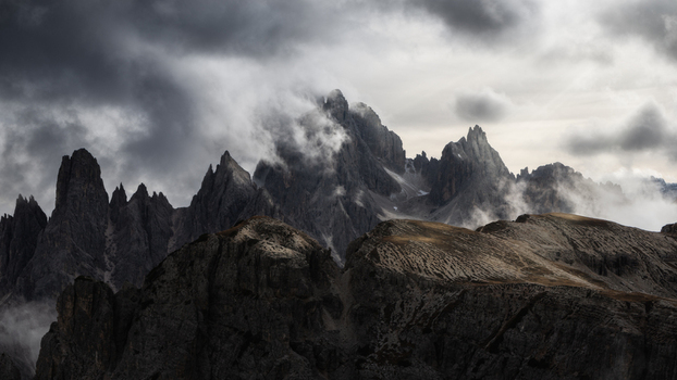 View of the jagged peaks of the Dolomites shrouded in dramatic clouds and mist Trentino Alto Adige Italy. View of the jagged peaks of the Dolomites shrouded in dramatic clouds and mist Trentino Alto Adige Italy.