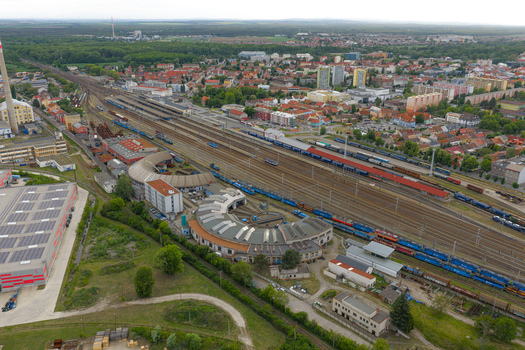 Aerial view of the railway station in Breclav featuring a historic roundhouse multiple tracks with freight trains and surrounding urban infrastructure in Breclav South Moravian Region Czechia.