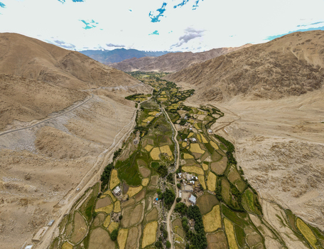 Aerial view of the rugged landscape of Ladakh with terraced fields and small settlements nestled in the valley Ladakh Division Ladakh India. Aerial view of the rugged landscape of Ladakh with terraced fields and small settlements nestled in the valley Ladakh Division Ladakh India.