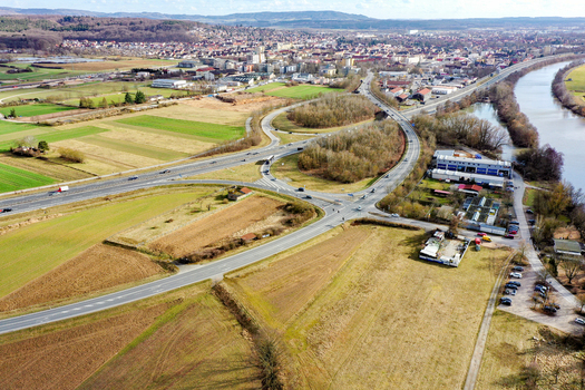 Aerial view of a highway interchange and road network surrounded by agricultural fields and the river Forchheim Bavaria Germany. Aerial view of a highway interchange and road network surrounded by agricultural fields and the river Forchheim Bavaria Germany.