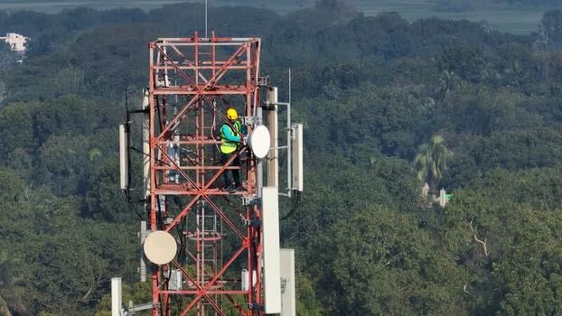 Aerial view of a technician working on a telecom tower Bangladesh.