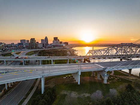Aerial view of the Louisville skyline complex highway interchanges and the Ohio River during a golden sunset Louisville Kentucky United States. Aerial view of the Louisville skyline complex highway interchanges and the Ohio River during a golden sunset Louisville Kentucky United States.