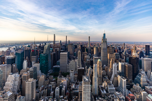 View of the dense New York City skyline with iconic skyscrapers and urban architecture under a clear blue sky in New York New York United States. View of the dense New York City skyline with iconic skyscrapers and urban architecture under a clear blue sky in New York New York United States.