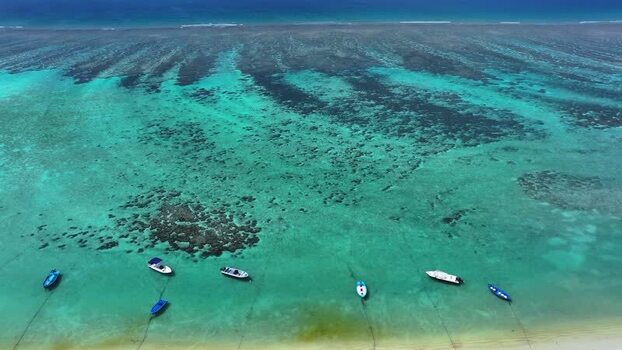 Aerial view of boats anchored in a turquoise lagoon Maldives. Aerial view of boats anchored in a turquoise lagoon Maldives.