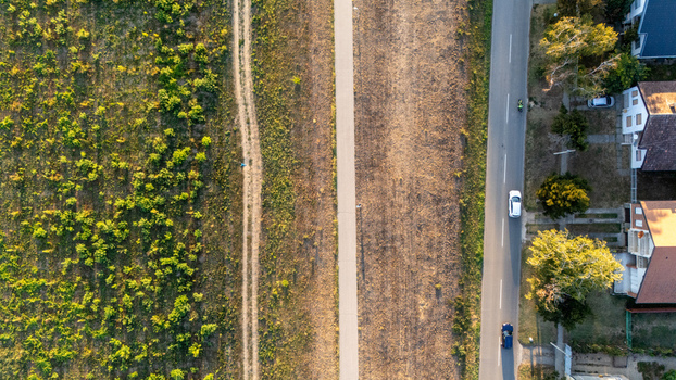 Aerial view of a road running alongside a field and residential houses in Sremska Mitrovica Vojvodina Serbia. Aerial view of a road running alongside a field and residential houses in Sremska Mitrovica Vojvodina Serbia.