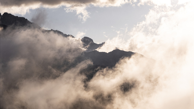 Aerial view of jagged peaks piercing a sea of ethereal clouds a dance of light and shadow over the rugged terrain Picos de Europa Asturias Spain. Aerial view of jagged peaks piercing a sea of ethereal clouds a dance of light and shadow over the rugged terrain Picos de Europa Asturias Spain.
