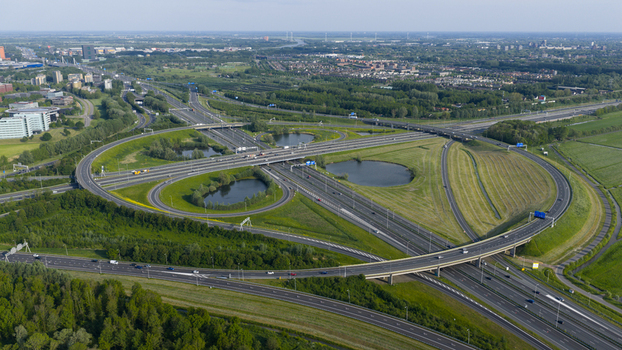 Aerial view of the Knooppunt Oudenrijn highway interchange with complex road networks green meadows and small ponds in Utrecht Utrecht Netherlands. Aerial view of the Knooppunt Oudenrijn highway interchange with complex road networks green meadows and small ponds in Utrecht Utrecht Netherlands.