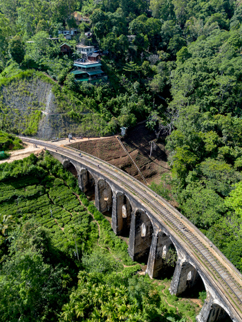 Aerial view of Nine Arch Bridge surrounded by lush tea plantations and dense forest in the mountains Demodara Uva Province Sri Lanka. Aerial view of Nine Arch Bridge surrounded by lush tea plantations and dense forest in the mountains Demodara Uva Province Sri Lanka.