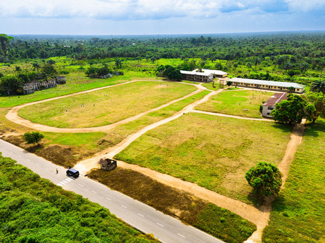 Aerial view of institutional buildings and a large grassy field surrounded by lush tropical forest in Ahoada I Rivers Nigeria. Aerial view of institutional buildings and a large grassy field surrounded by lush tropical forest in Ahoada I Rivers Nigeria.
