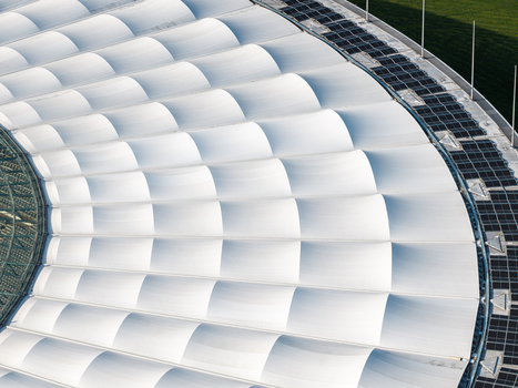 Berlin Germany 26 September 2026 Aerial view of Olympiastadion Berlin showing the distinctive white membrane roof structure with its repeating curved panels and integrated solar panels.