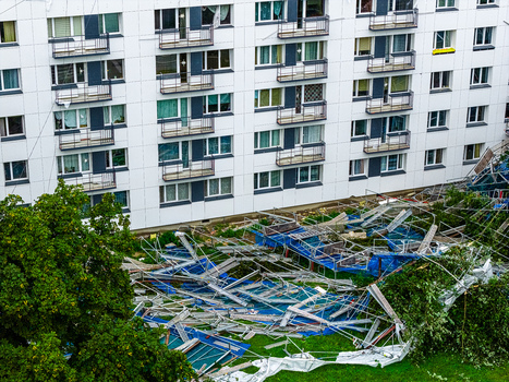 Riga Latvia 23 August 2026 Aerial view of storm damage with scattered debris and collapsed scaffolding near a residential apartment building.