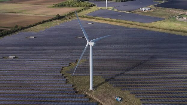 Aerial view of wind turbine and solar farm in United Kingdom. Aerial view of wind turbine and solar farm in United Kingdom.
