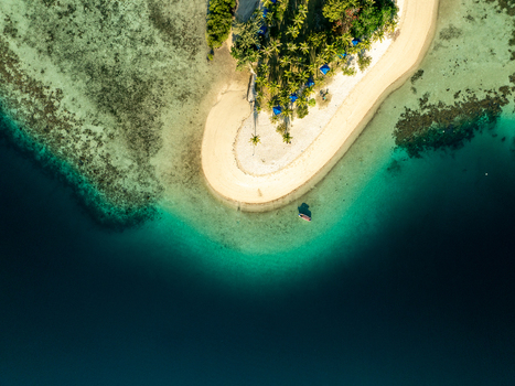 Aerial view of Pass Island with its white sand beach turquoise shallow waters coral reefs and lush palm trees in Coron Philippines. Aerial view of Pass Island with its white sand beach turquoise shallow waters coral reefs and lush palm trees in Coron Philippines.