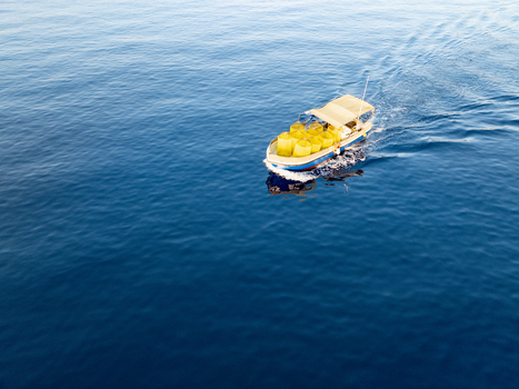 Aerial view of a boat sailing on the crystal clear blue waters of the sea Ghajnsielem gozo Malta. Aerial view of a boat sailing on the crystal clear blue waters of the sea Ghajnsielem gozo Malta.
