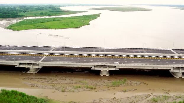 Aerial view of a modern highway bridge over the river in India. Aerial view of a modern highway bridge over the river in India.