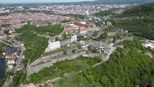 Aerial view of the historic Besancon Citadel with its massive stone fortifications and rooftops overlooking the city and river in Besancon Bourgogne Franche Comte France. Aerial view of the historic Besancon Citadel with its massive stone fortifications and rooftops overlooking the city and river in Besancon Bourgogne Franche Comte France.