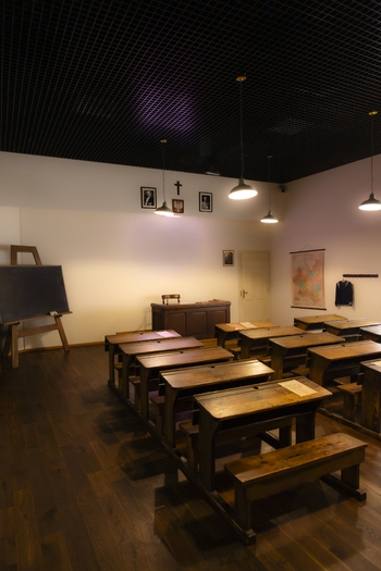 View of a historic classroom with wooden desks a blackboard and a teacher s desk in Gdansk Pomeranian Voivodeship Poland. View of a historic classroom with wooden desks a blackboard and a teacher s desk in Gdansk Pomeranian Voivodeship Poland.