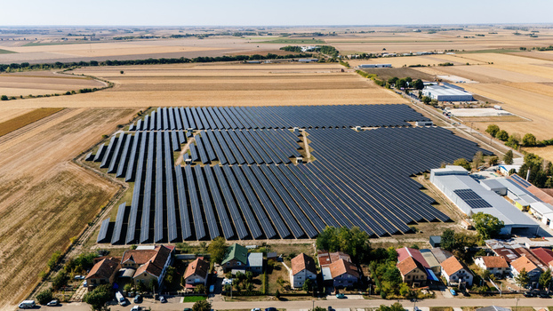 Aerial view of a large solar farm with rows of photovoltaic panels situated near residential houses and agricultural fields in Temerin Vojvodina Serbia. Aerial view of a large solar farm with rows of photovoltaic panels situated near residential houses and agricultural fields in Temerin Vojvodina Serbia.