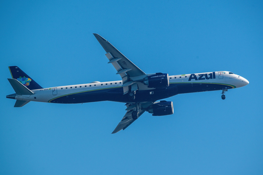 Rio de Janeiro Brazil 06 June 2026 View of an Azul Brazilian Airlines Embraer E2 jet aircraft flying in a clear blue sky with landing gear extended.